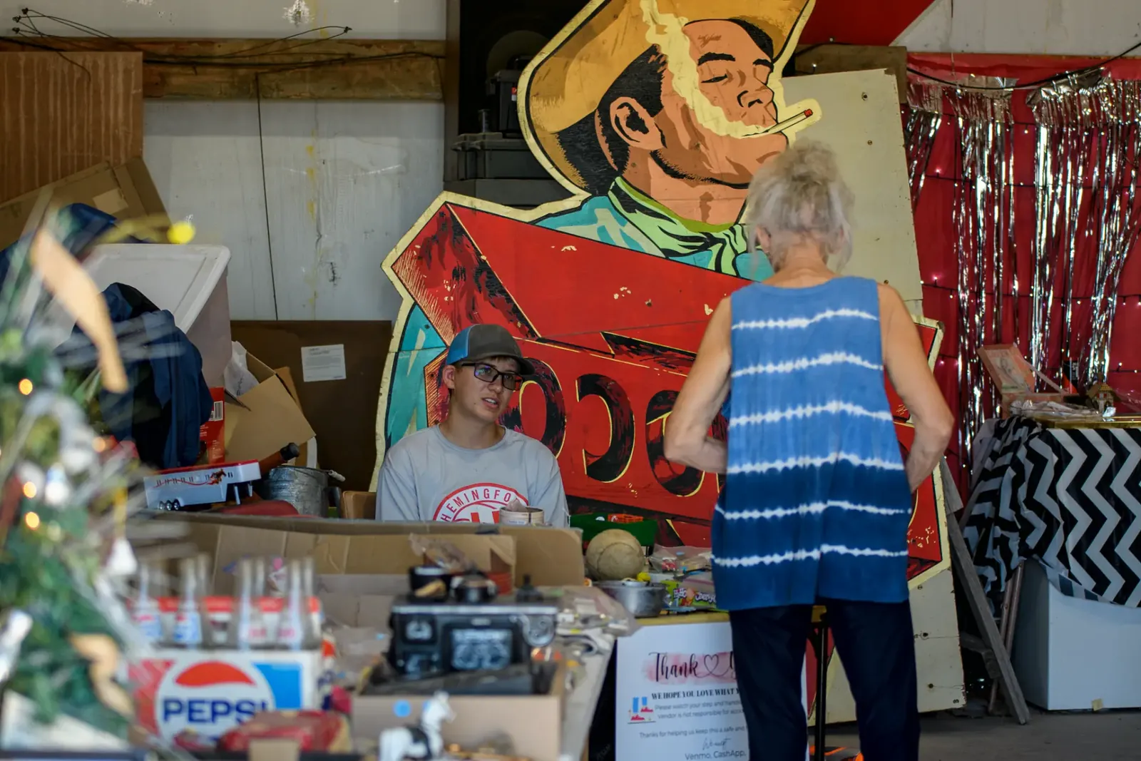 Two people talking at a vintage market display