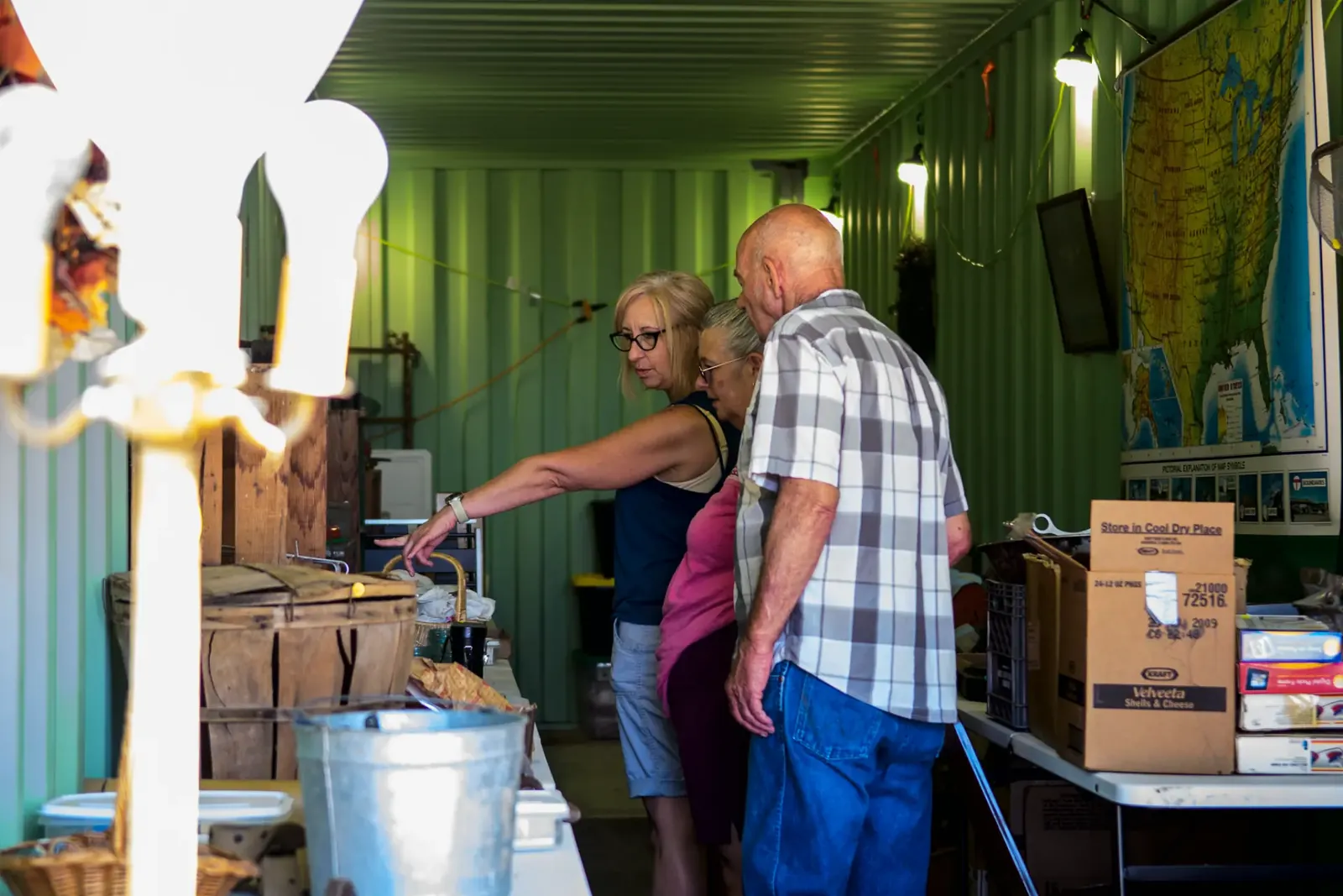 Visitors browsing vintage goods inside a green market booth